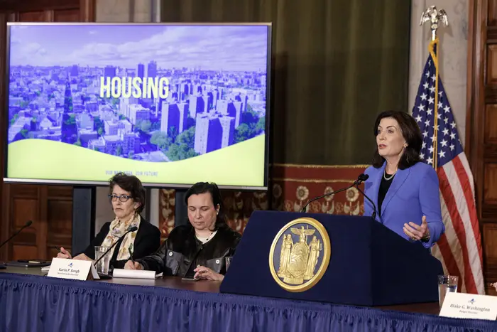 Gov. Kathy Hochul and members of her cabinet show a presentation on housing.